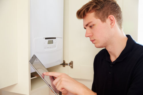 engineer servicing a boiler