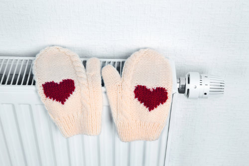 central heating radiator with mittens on with hearts